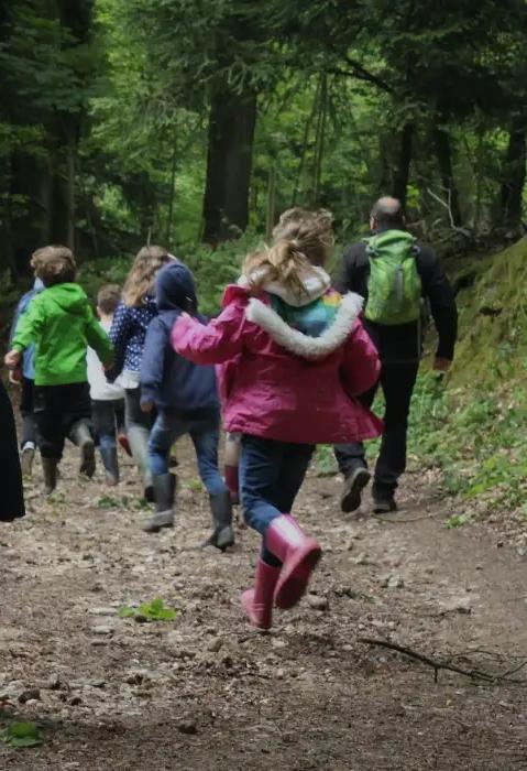 Children running in the woods