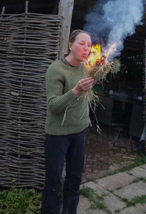 Woman blowing on fire